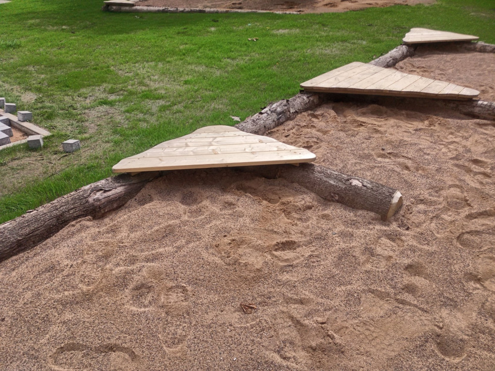 Sandkasteneinfassung aus Natur-Baumstämmen